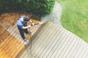 a professional pressure washing a dirty roof