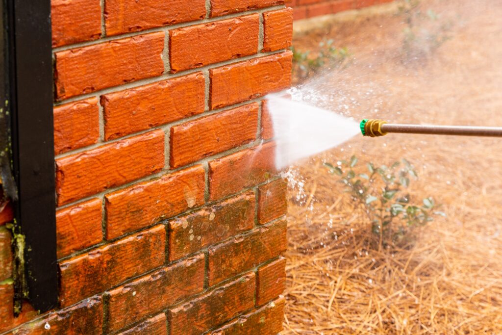 pressure,washer,using,water,to,clean,a,dirty,brick,wall